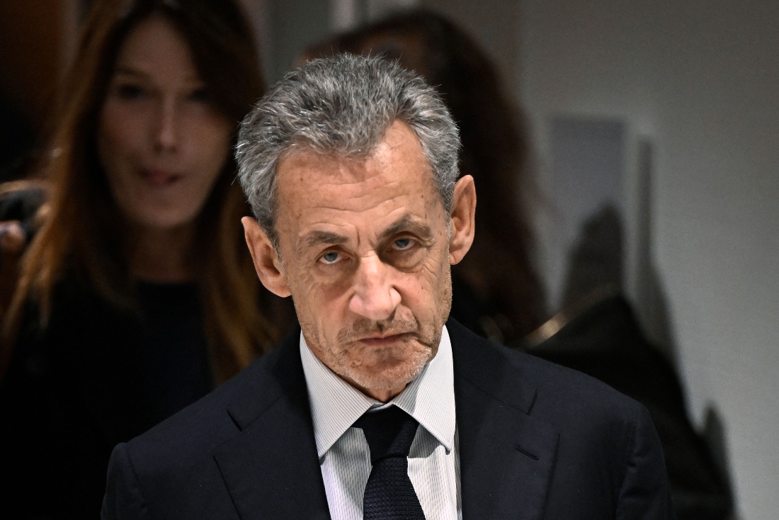 Former French president Nicolas Sarkozy leaves in front of his wife French-Italian singer Carla Bruni after the verdict in his trial at the Tribunal de Paris courthouse in Paris, France. (AFP)