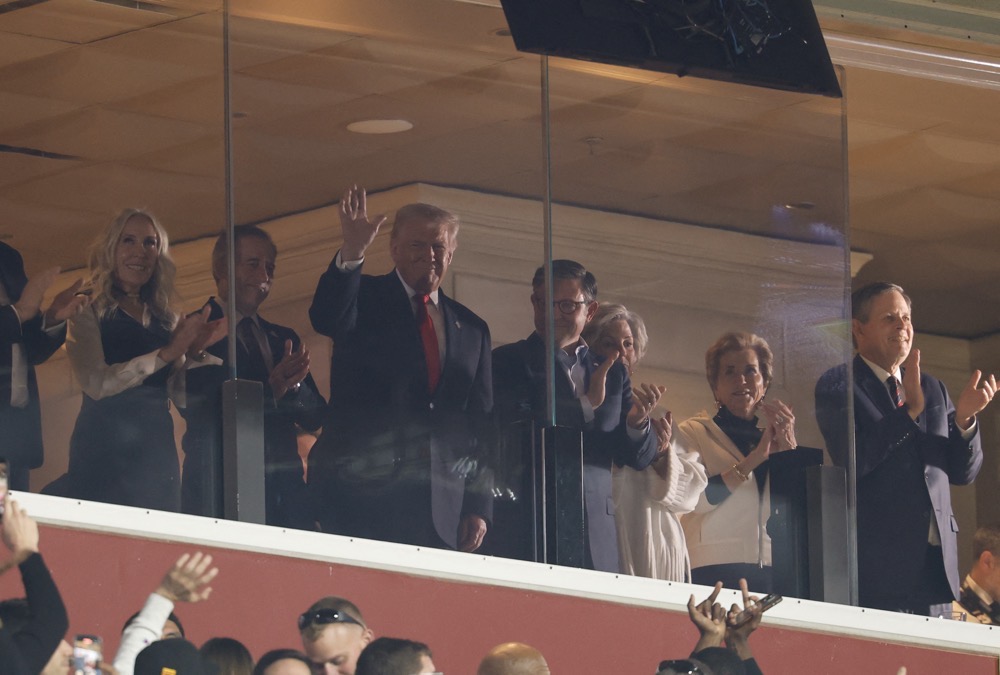 President Donald Trump waves while attending the Washington Commanders games against the Detroit Lions. (Imagn Images/Reuters)
