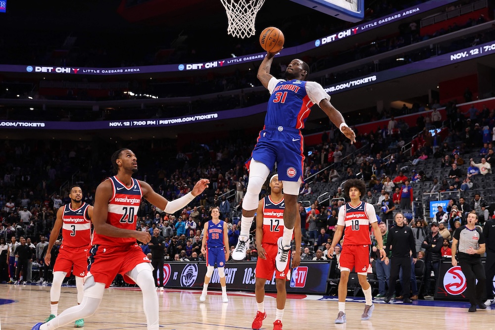 Javonte Green of the Detroit Pistons dunks in overtime next to Alex Sarr of the Washington Wizards at Little Caesars Arena on Monday in Detroit, Michigan. (Getty Images via AFP)