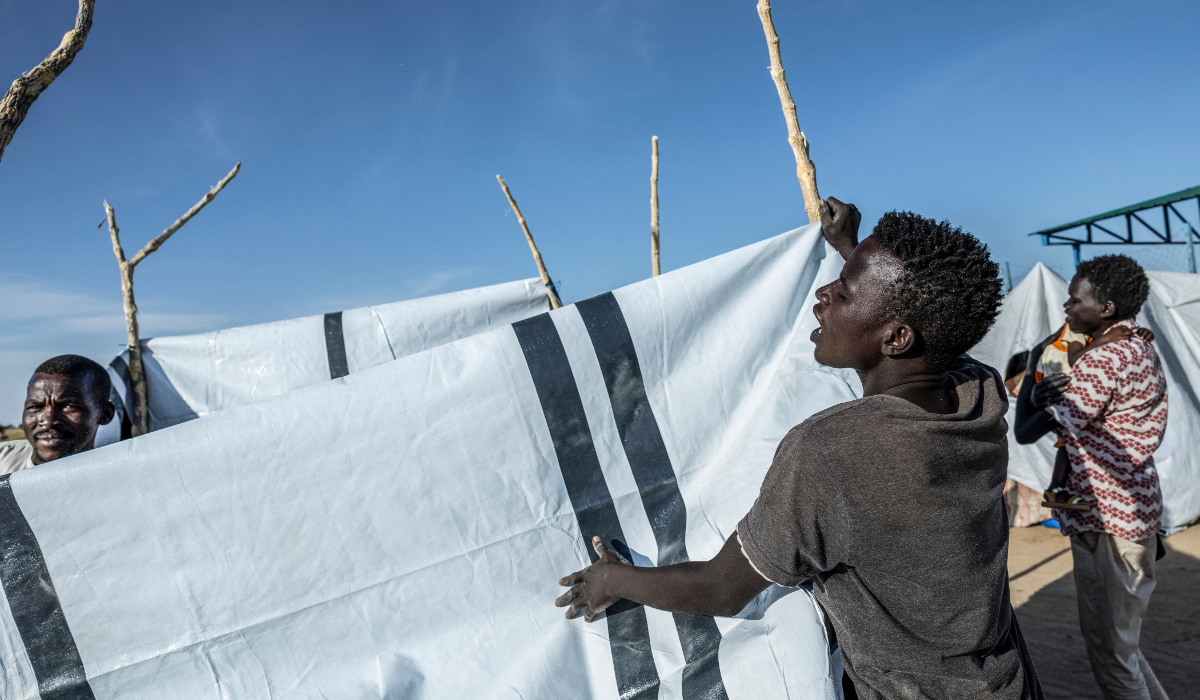 Sudanese refugees construct a shelter at the Tine transit camp in Chad on November 8, 2025. (AFP)
