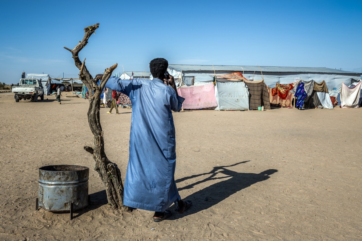 A Sudanese refugee speaks on the phone at the Tine transit camp in Chad, Nov. 8, 2025. (AFP)