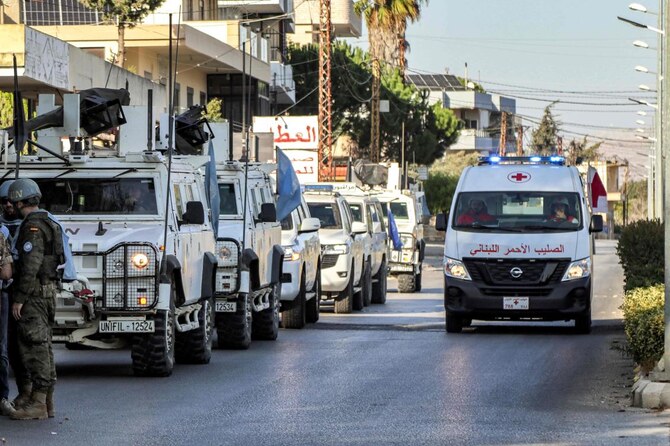 A Lebanese Red Cross ambulance moves past armored vehicles of the United Nations Interim Force in Lebanon during their patrol around Marjayoun in south Lebanon last year. (AFP/File Photo)