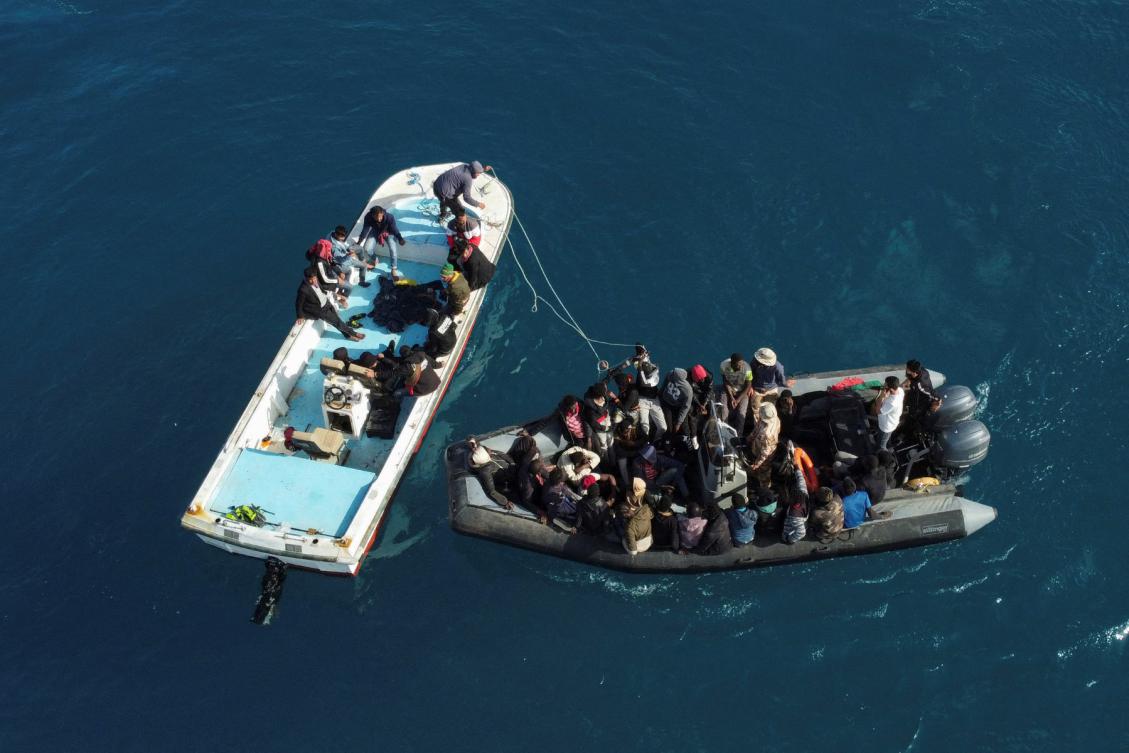 An aerial picture shows boats transporting migrants of different nationalities entering a port in the Garabulli area following their rescue at sea by the Libyan Coast Guard, on April 25, 2023.