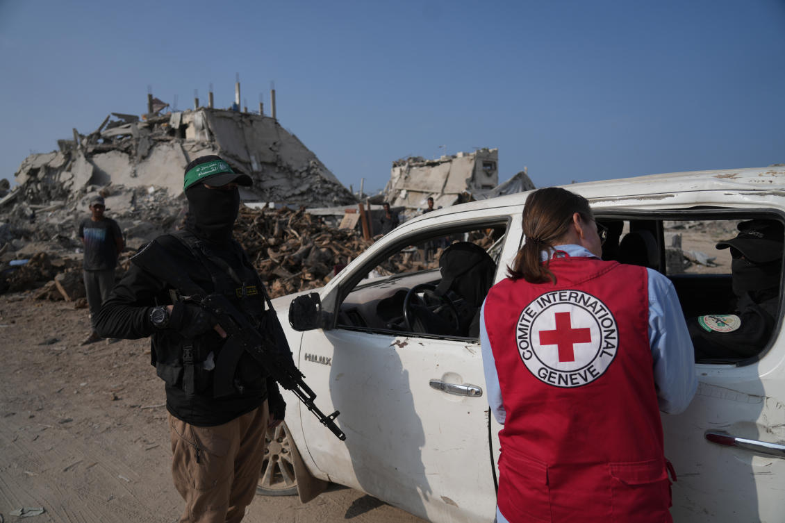 Hamas militants accompanied by members of the International Committee of the Red Cross (ICRC) head to east of Gaza City to search for the bodies of hostages, Thursday, Nov. 13, 2025. (AP)