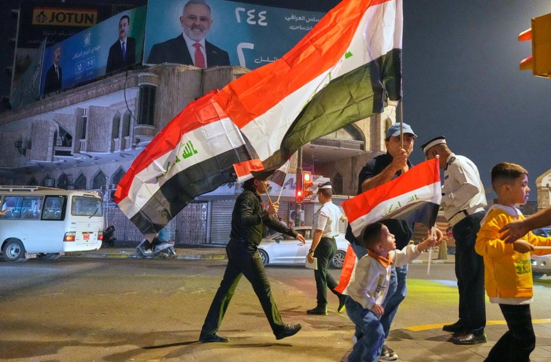 Supporters of Iraqi Prime Minister Mohammed Shia al-Sudani cheer in Tahrir Square, Baghdad, Iraq. (AP)