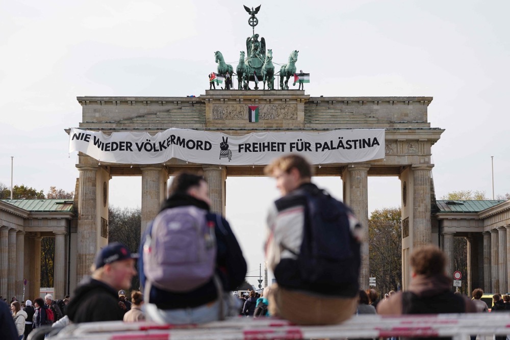 Pro-Palestine activists stand on top of Berlin's landmark Brandenburg Gate. (dpa/AFP)