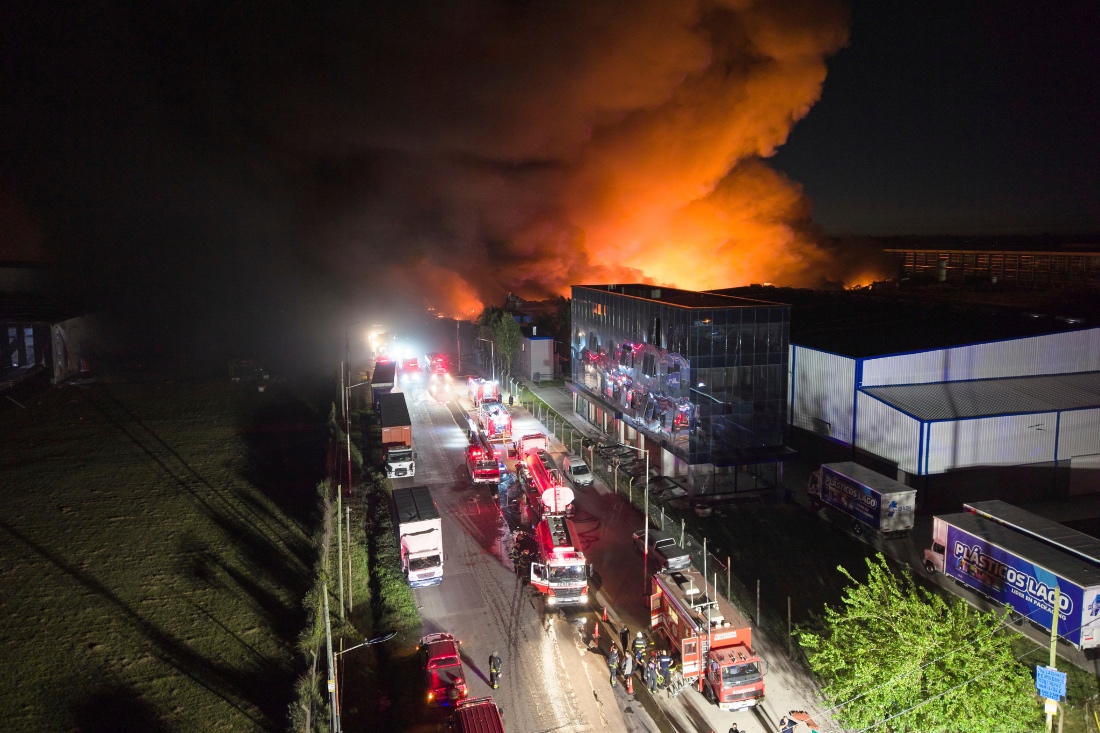 Firefighters work to control a fire at an industrial park in Ezeiza, Argentina. (AP)