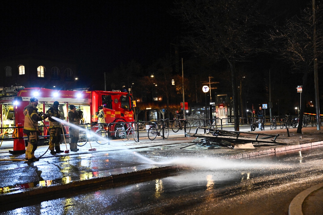Firefighters spray water at the scene of the accident after a bus crashed into a bus stop in Östermalm in Stockholm, Sweden. (AP)