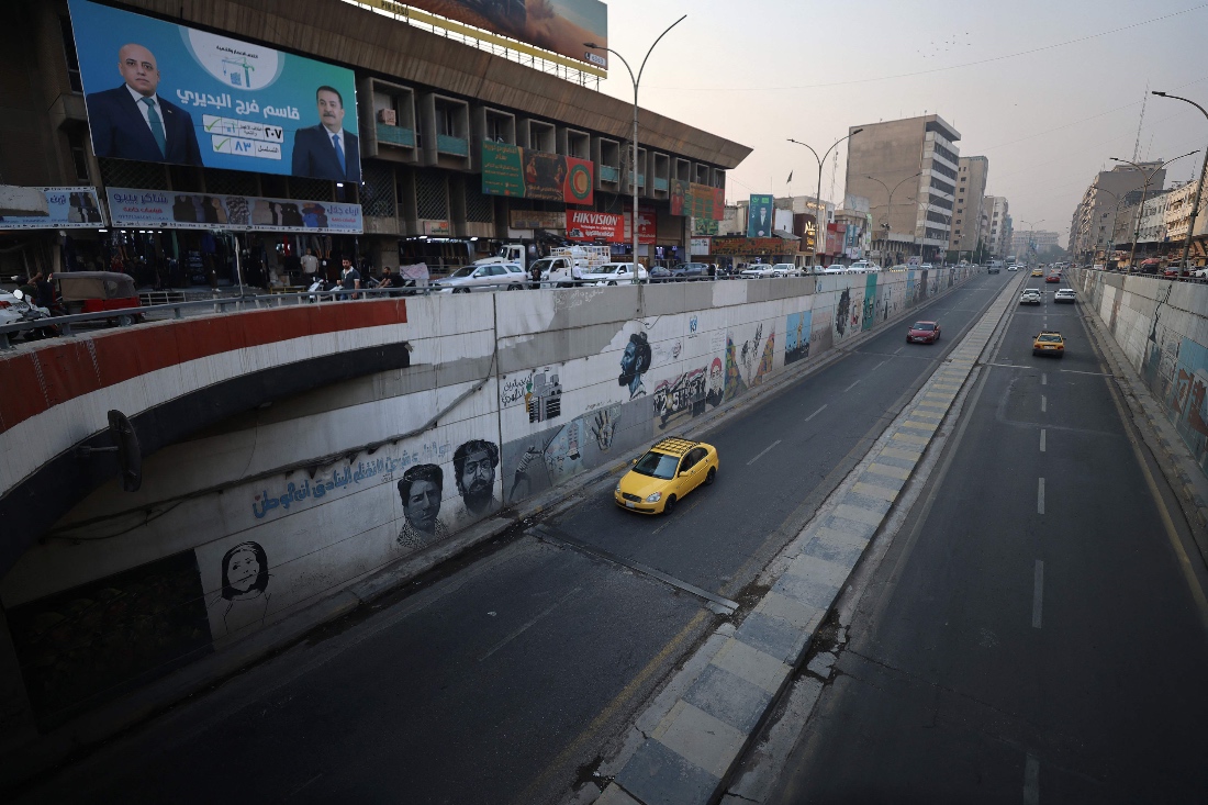 Traffic goes past an electoral poster for the "Reconstruction and Development" list of Iraqi Prime Minister Mohammed Shia al-Sudani (R) in the Shorja area of central Baghdad, Iraq. (AFP)