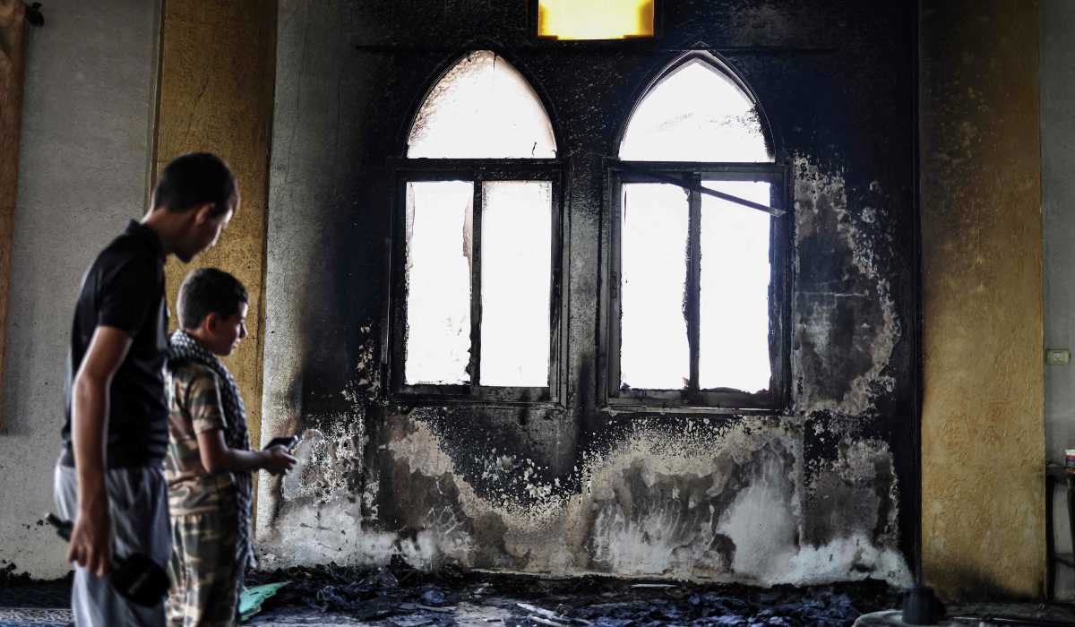 Young Palestinians look at the damage in the Hajja Hamida Mosque after it was reportedly set on fire and vandalised by Israeli settlers in the Palestinian village of Deir Istiya, near Salfit in the Israeli-occupied West Bank, on November 13, 2025. (AFP)