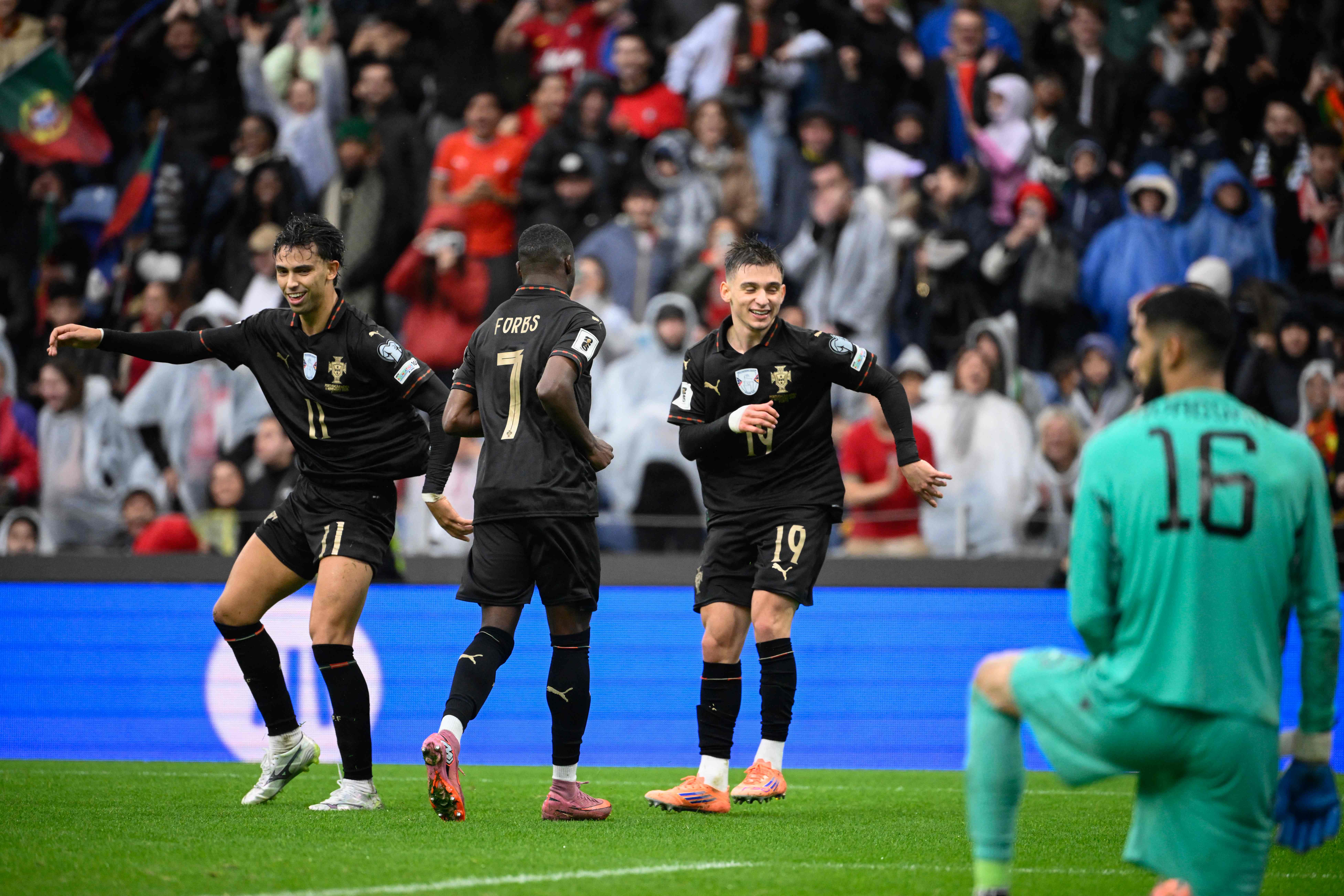Portugal’s defender #19 Francisco Conceicao (R) celebrates with teammates after scoring their ninth goal during the 2026 World Cup qualifiers Europe zone group F football match between Portugal and Armenia, at Dragao stadium in Porto on November 16, 2025. (AFP)