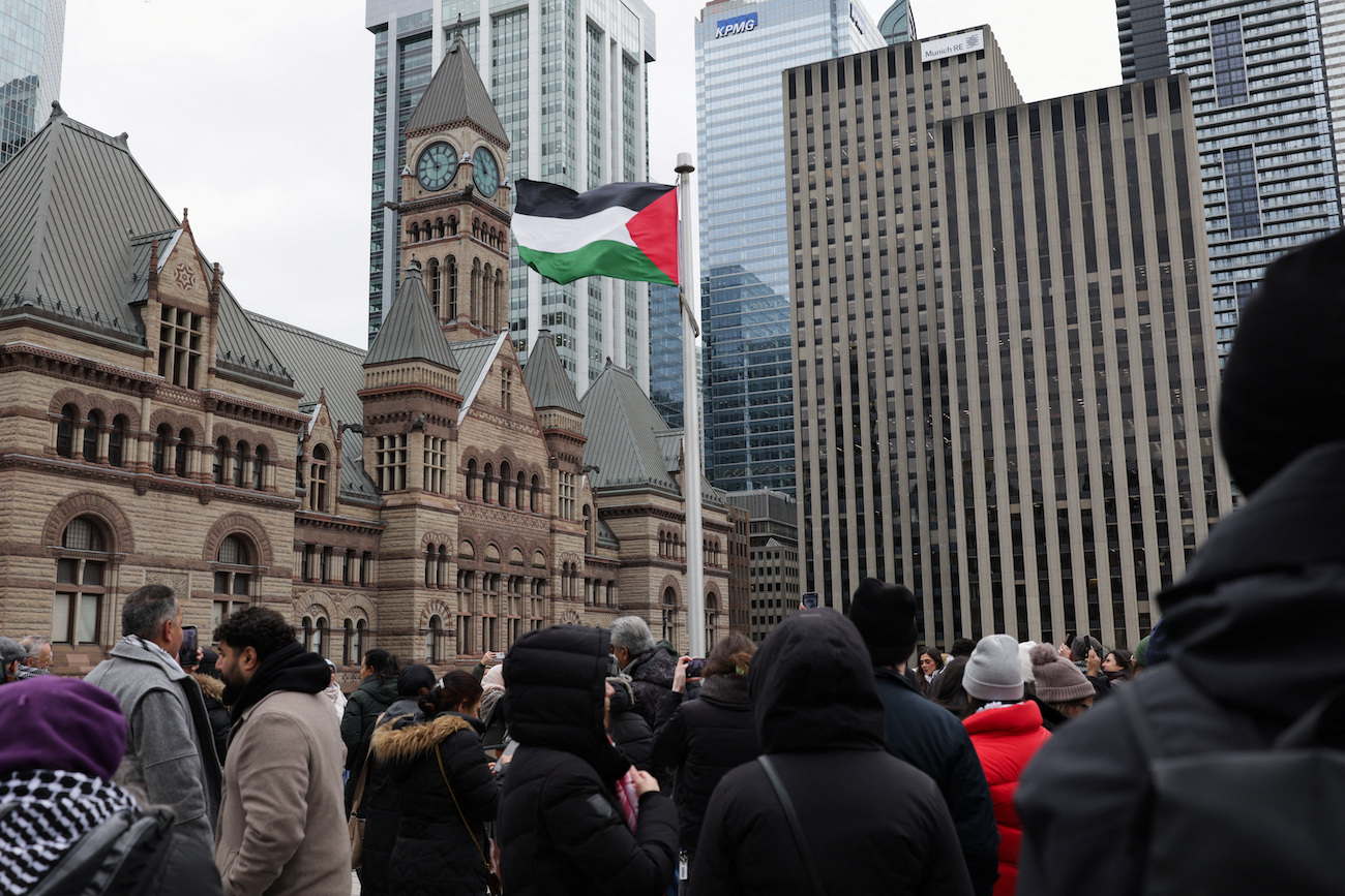People gather in support of Palestinians as the Palestinian flag flies over Toronto’s City Hall after Canada officially recognized the State of Palestine in September, in Toronto, Canada, November 17, 2025. (Reuters)