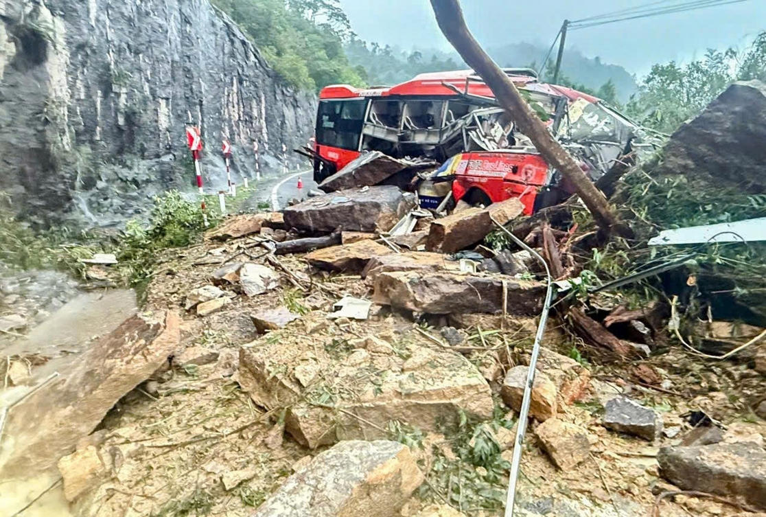 A passenger bus is crushed by a fatal landslide on Khanh Le pass in Khanh Hoa province, Vietnam on Nov. 17, 2025. (VNExpress via AP)