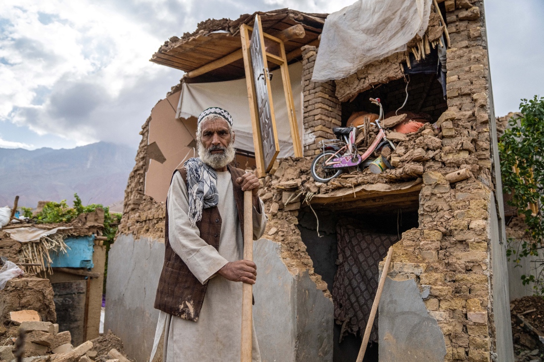 An Afghan man stands in front of his damaged house, in the aftermath of an earthquake at a village in the Khulm district of Samangan province. (AFP)