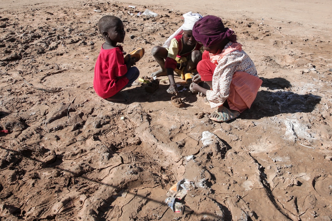 Children displaced from El-Fasher play in the dirt at the newly established El-Afadh camp in Al Dabbah, in Sudan's Northern State. (AP)