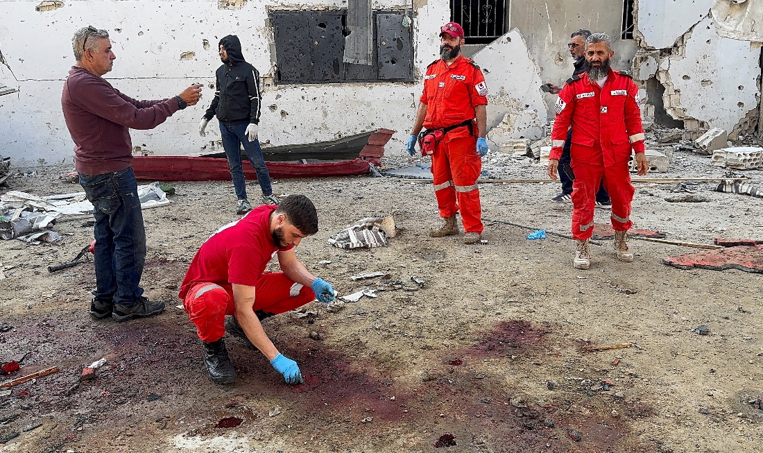 Paramedics and people gather at the site of the Israeli strike that killed several people yesterday night, according to the Lebanese Health Ministry, inside the Ain al-Hilweh Palestinian refugee camp in the southern city of Sidon, Lebanon. (Reuters)