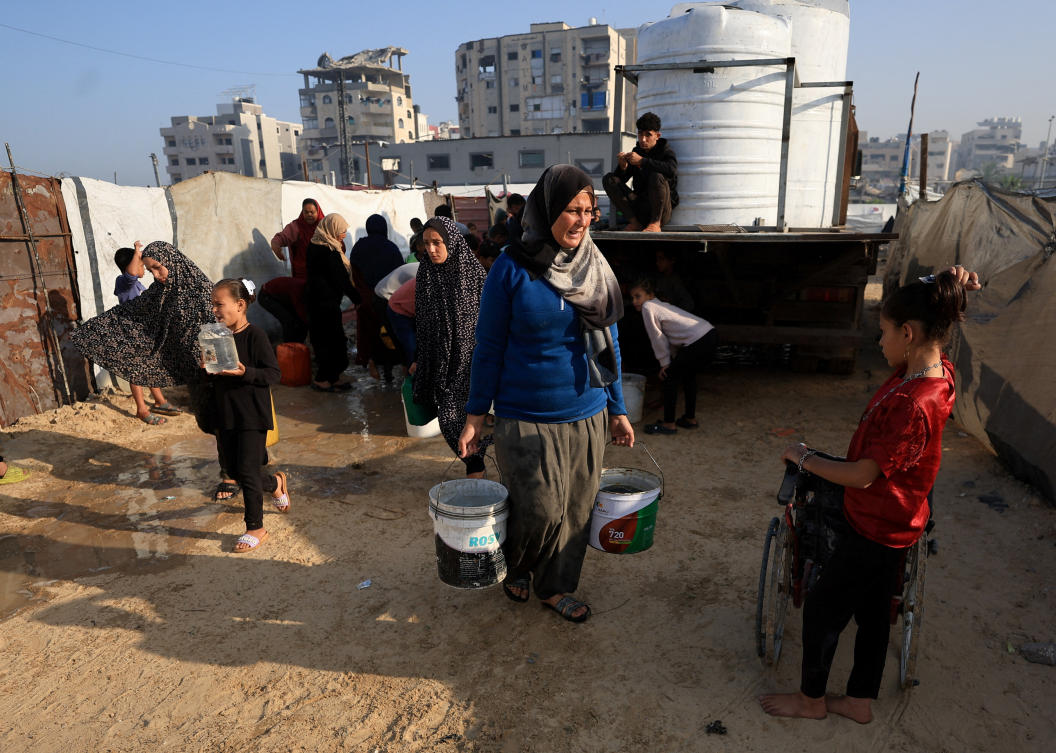 Palestinians gather to collect water, amid a ceasefire between Israel and Hamas, in Gaza City, Nov. 19, 2025. (Reuters)