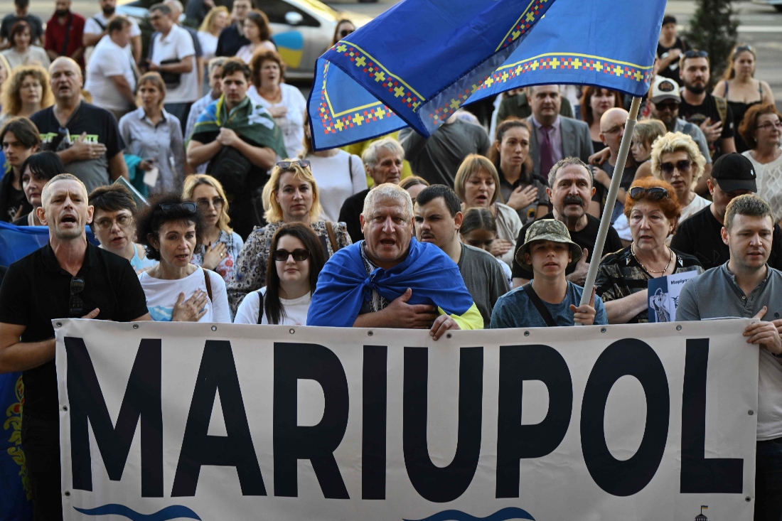 Former residents of Mariupol, who were forced to leave their homes due to the Russian invasion take part in a meeting in central Kyiv, Ukraine. (AFP)