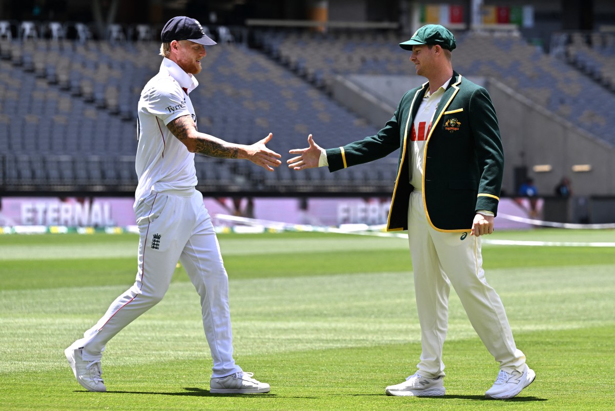 Australia captain Steve Smith (R) shakes hands with England captain Ben Stokes before a media event with the Waterford Crystal Ashes trophy at Perth Stadium in Perth on November 20, 2025. (File/AFP)