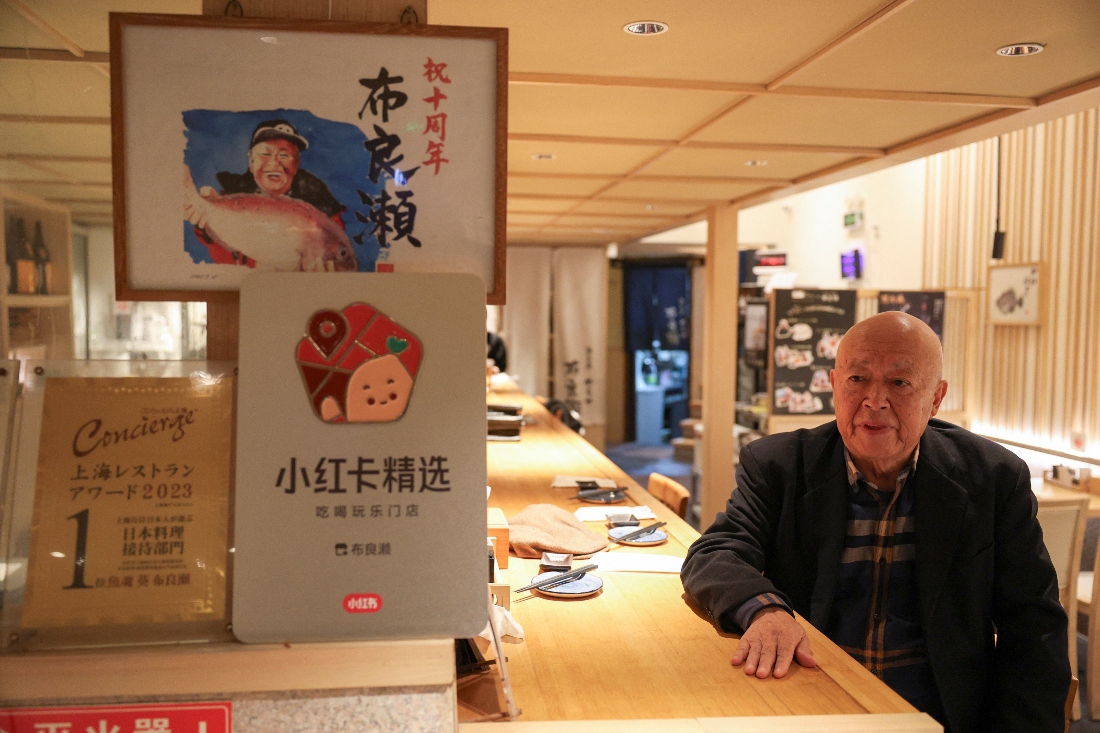 Takashi Ito, the owner of the Japanese restaurant Merase, which serves seafood such as sushi and sashimi, speaks during an interview in Shanghai, China. (Reuters)