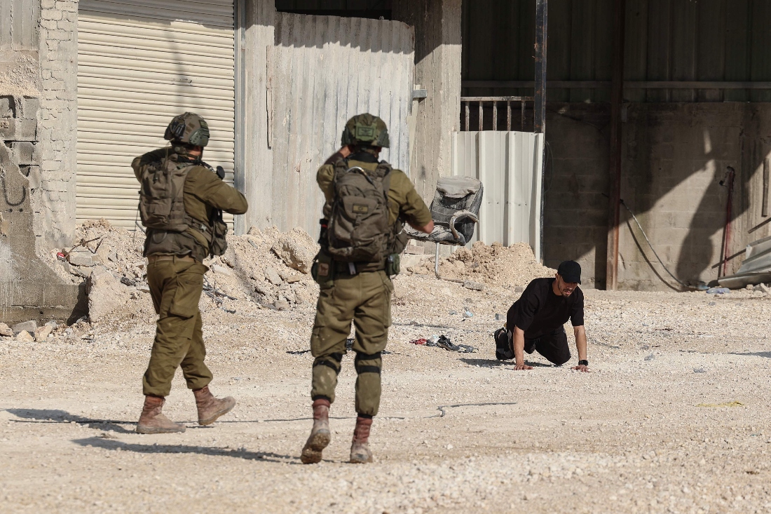 Israeli soldiers detain a Palestinian resident of the Nur Shams refugee camp, near Tulkarem in the Israeli-occupied West Bank. (AFP)