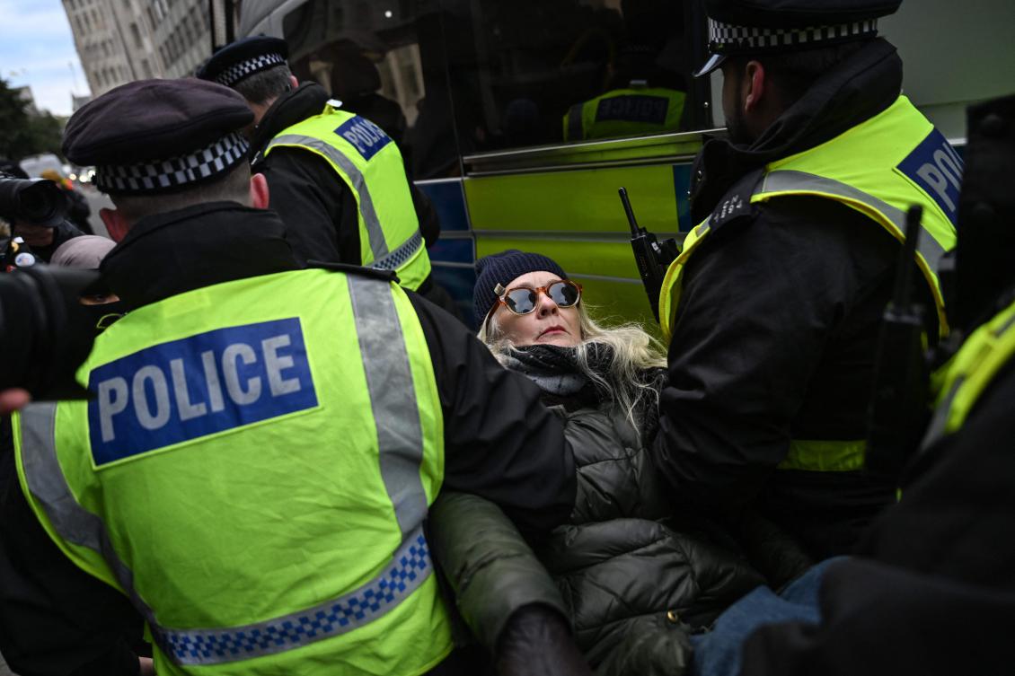 Police remove a protester for taking part in a demonstration in support of ‘Defend Our Juries’ and their campaign against the ban on Palestine Action, London, England, Nov. 20, 2025. (AFP)