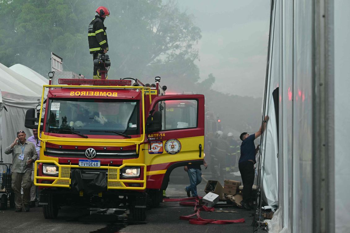 Firefighters battle a fire that broke out in a pavilion at the COP30 UN Climate Change Conference venue in Belem, Para state, Brazil, Nov. 20, 2025. (Pablo PORCIUNCULA / AFP)