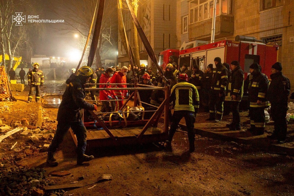 Rescuers transport the body of a person found under debris of an apartment building which was hit by a Russian missile strike in Ternopil, Ukraine. (Reuters)