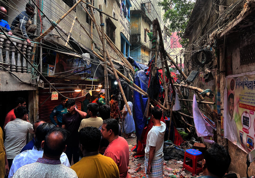 Residents stand in an alley after vacating their house next to a fallen scaffolding following an earthquake in Dhaka, Bangladesh on Nov. 21, 2025. (Reuters)
