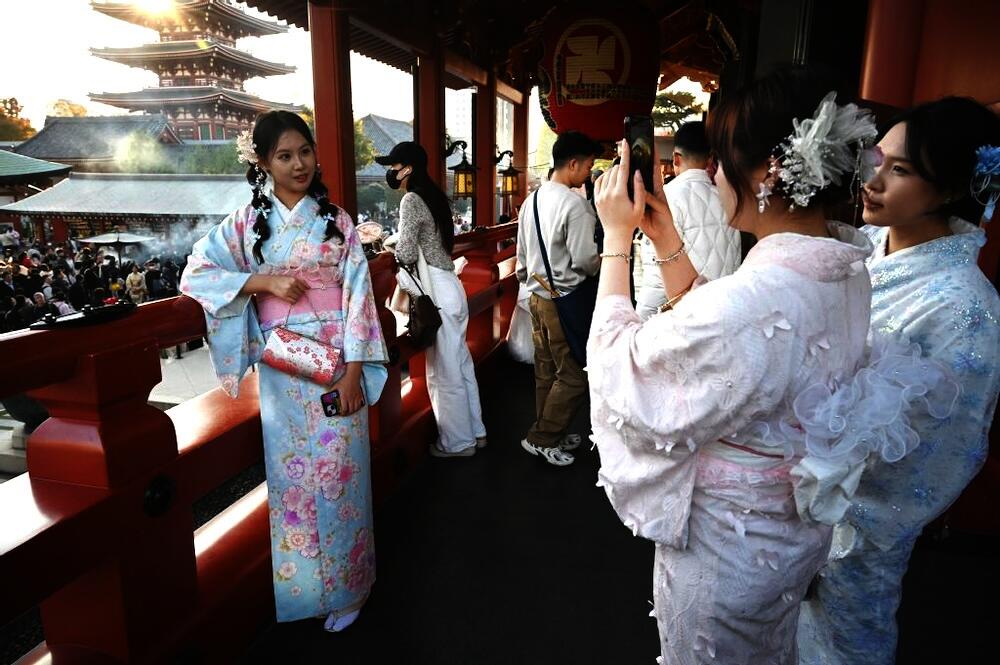 Above, Chinese tourists wear kimonos as they visit the Sensoji Temple in the Asakusa district of Tokyo on Nov. 15, 2025. (AFP)