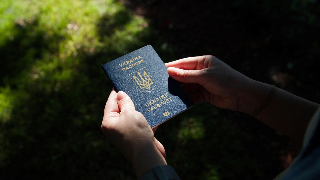 Kateryna Golizdra holds her Ukrainian passport for a photograph outside her home in Margate, Florida, U.S. (Reuters)