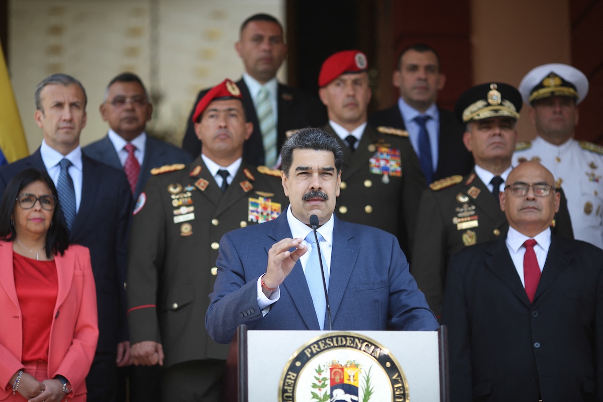 Venezuela's President Nicolas Maduro (C) being flanked by Vice-President Delcy Rodriguez (L) and Health Minister Carlos Alvarado (R) as he speaks during a press conference. (FILE/AFP)