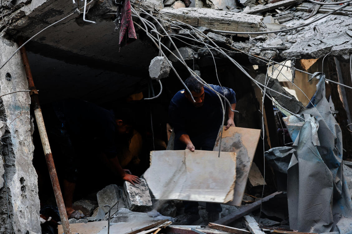 Palestinians inspect the site of Saturday’s Israeli strike in the Central Gaza Strip on Nov. 23, 2025. (Reuters)