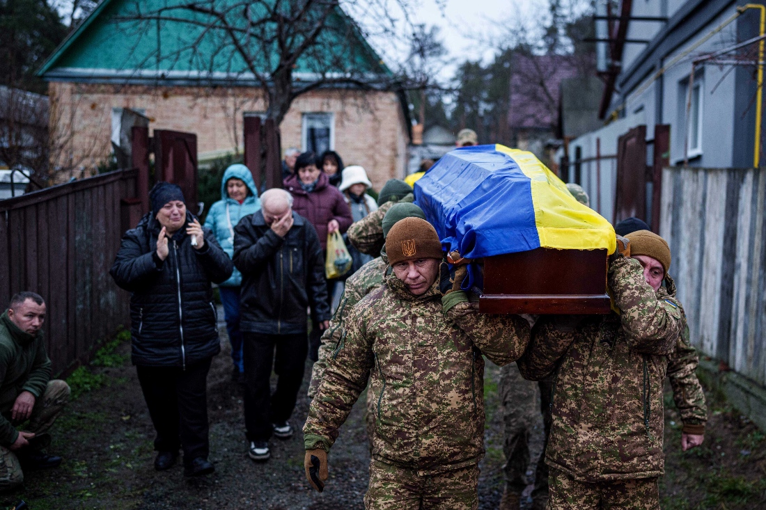 An honor guard carries the coffin of Ruslan Zhygunov, a Ukrainian serviceman, who was killed at the frontline near Rusyn Yar village, during his funeral ceremony in Hostomel, Ukraine. (AP)