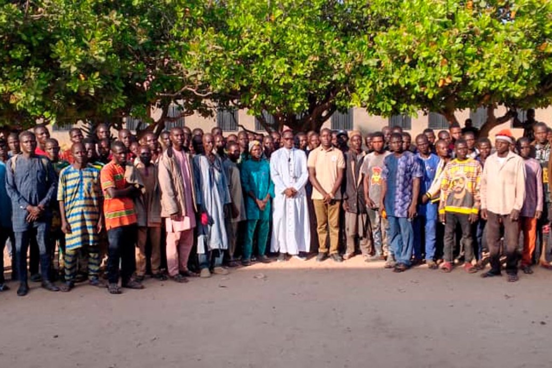 A photo shows relatives of abducted children pose for a photograph in the courtyard of St. Mary’s Catholic School in Papiri, Agwarra local government, Niger state. (Handout/AFP)