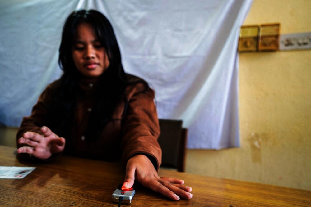 A young girl’s biometrics is being taken by a poll official as she registers her name in the voter list at the District Election Office in Lalitpur, ahead of Nepal’s parliamentary elections, on Nov. 18, 2025. (AFP)