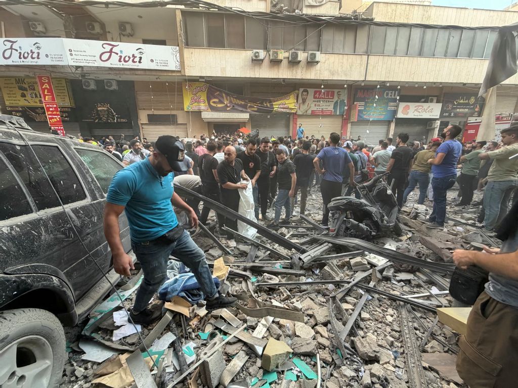 People gather looking at the debris following a targeted Israeli military strike on a residential building in the Haret Hreik neighbourhood of Beirut’s southern suburbs on November 23, 2025. (AFP)