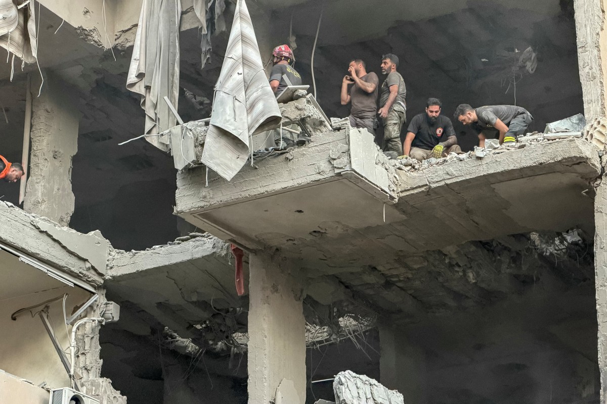 Rescuers search for survivors at the site of an Israeli air attack that targeted a residential building in Beirut’s southern Haret Hreik neighborhood, Nov. 23, 2025. (AFP)