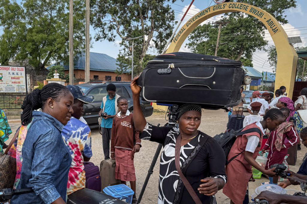 Relatives and students leave the Federal Government Girls College in Bwari, on the outskirts of Abuja, on November 22, 2025. The national education ministry ordered 47 boarding secondary schools across the country be shut following after gunmen kidnapped more than 300 students and teachers from a Catholic school. (AFP)