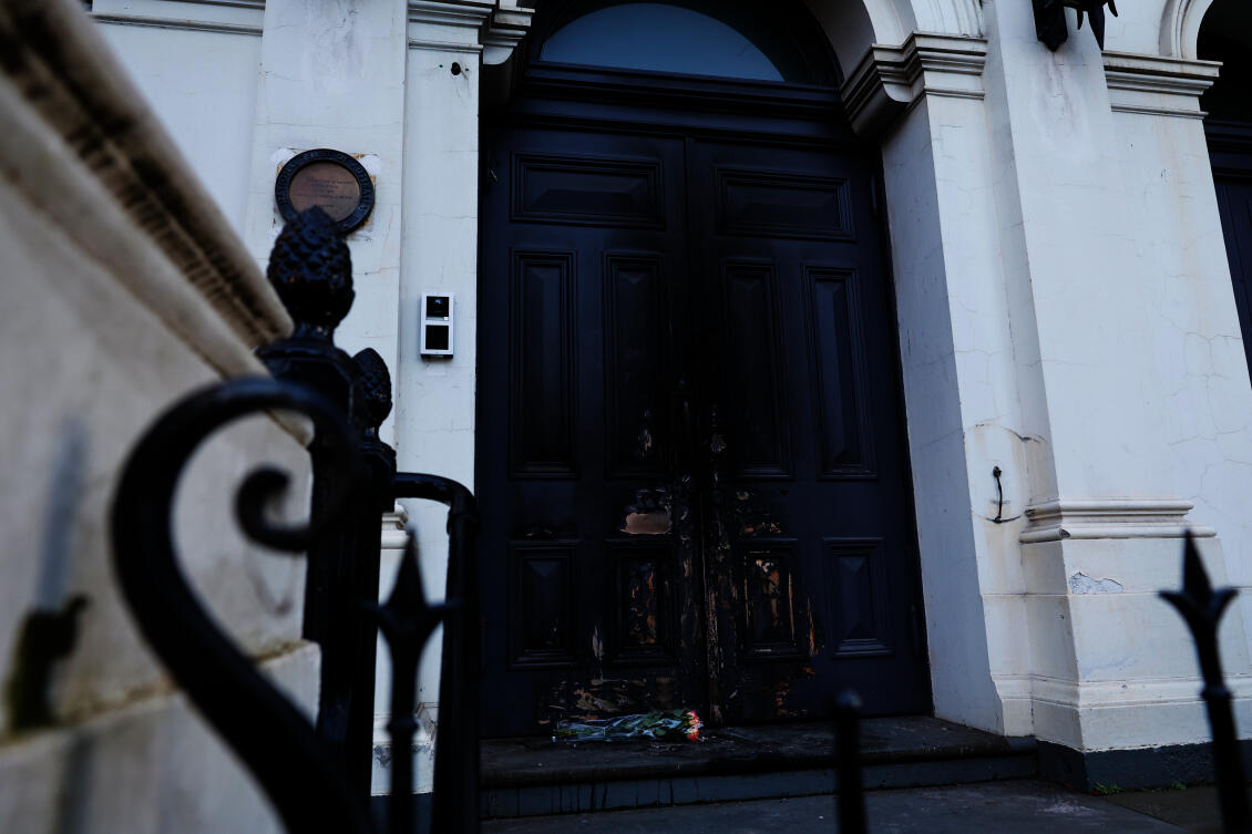 Flowers are left at the fire-damaged door of the East Melbourne Synagogue in Melbourne, Australia, July 7, 2025, following an arson attack. (AP)