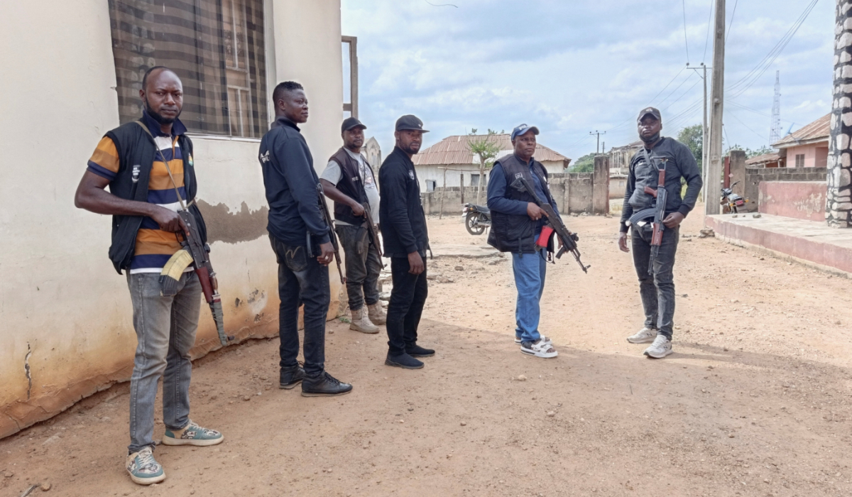 Police officers providing security hold weapons outside the Christ Apostolic Church during a Sunday service held for those killed and kidnapped in an attack by gunmen on November 18, in the town of Eruku, Kwara state, Nigeria, November 23, 2025. (REUTERS)