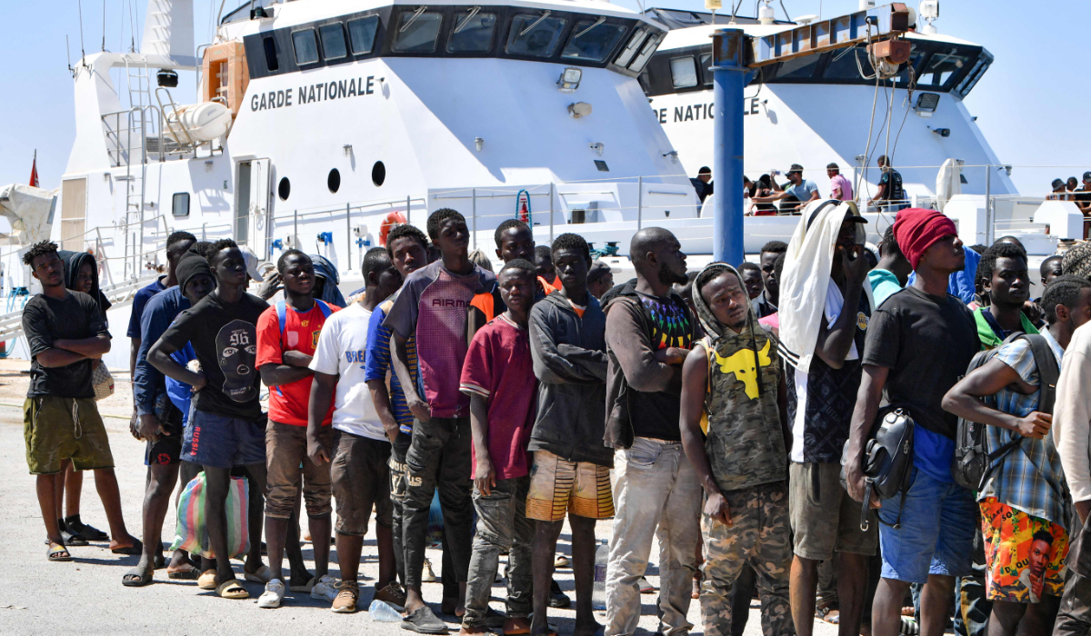 Migrants of African origin trying to flee to Europe, disembark in Sfax from a ship owned by the Tunisian coast guards, after being intercepted by them at sea on August 10, 2023. (AFP)