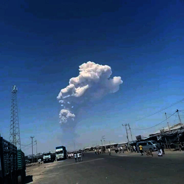 In this photo released by the Afar Government Communication Bureau, people watch ash billow from the first time eruption of the Hayli Gubbi Volcano in Ethiopia's Afar region Sunday, Nov. 23, 2025. (Afar Government Communication Bureau via AP)