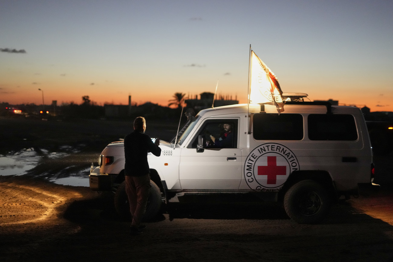 Red Cross convoy carrying the remains of a person believed to be a deceased hostage handed over by Gaza militants makes its way toward the border crossing with Israel, in Deir Al-Balah, central Gaza Strip, Nov. 25, 2025. (AP)