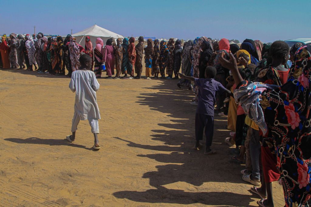 Sudanese women who fled El-Fasher line up to receive humanitarian aid at the Al-Afad camp for displaced people in the town of Al-Dabba, northern Sudan, Tuesday. (AFP)