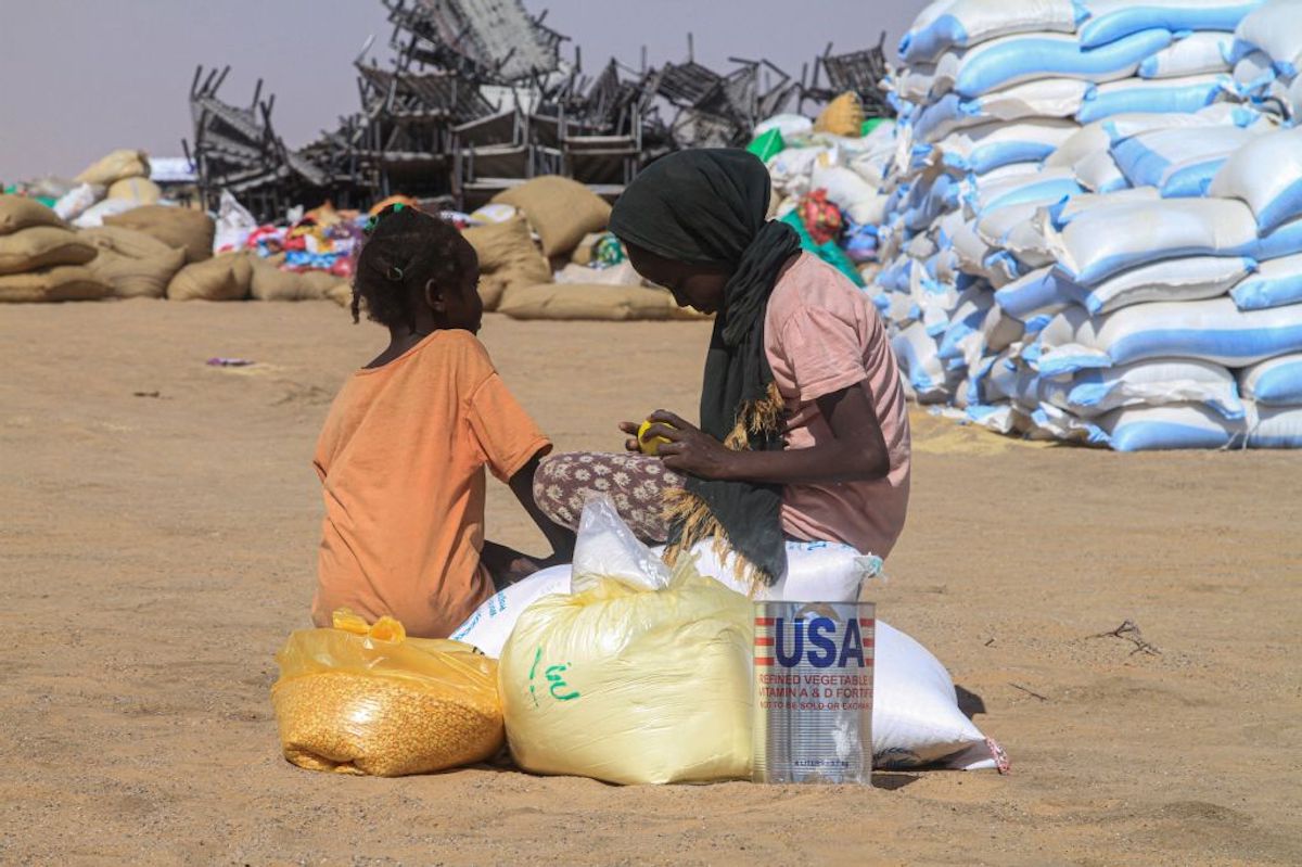 Sudanese girls who fled El-Fasher receive humanitarian aid at the Al-Afad camp for displaced people in Al-Dabba, northern Sudan, on Tuesday. (AFP)