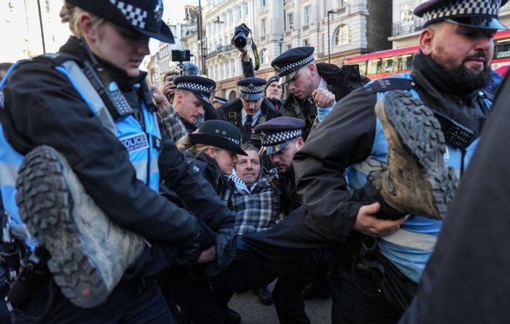 Police remove a protester, who was taking part in a demonstration against the ban on Palestine Action, outside the Royal Courts of Justice, London, England, Nov. 26, 2025. (AFP)