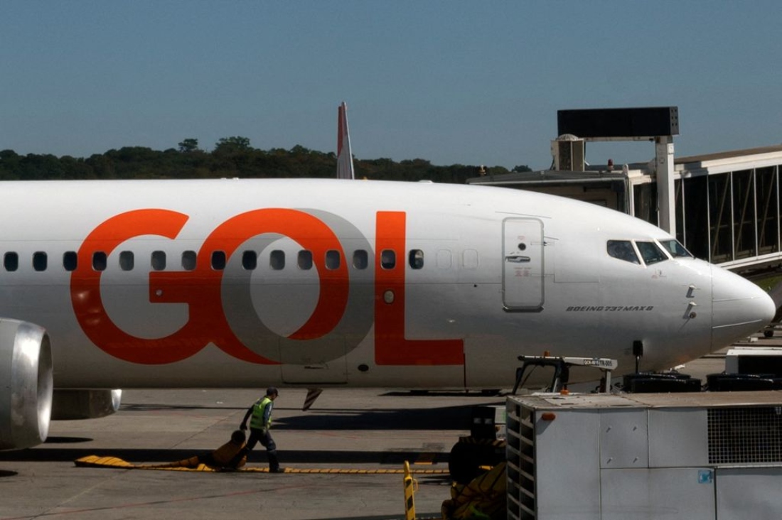 A worker walks in front of a Gol airline plane at Guarulhos airport in Sao Paulo, Brazil. (AFP)