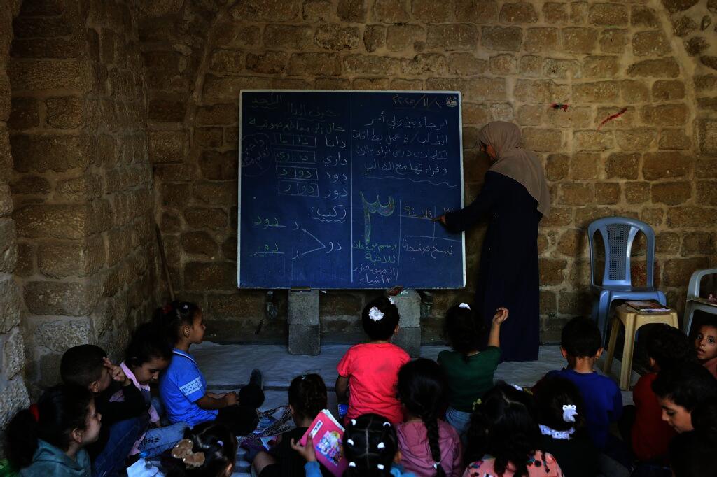 With no backpack, books or uniform, 11-year-old Layan Hajji navigates the ruins of Gaza City and heads to a makeshift classroom after two years of war halted her education. (AFP)