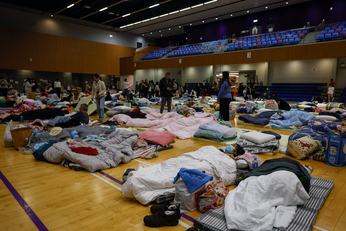 People shelter at an evacuation center on Thursday, after a deadly fire broke out at Wang Fuk Court housing complex, in Hong Kong. (Reuters)